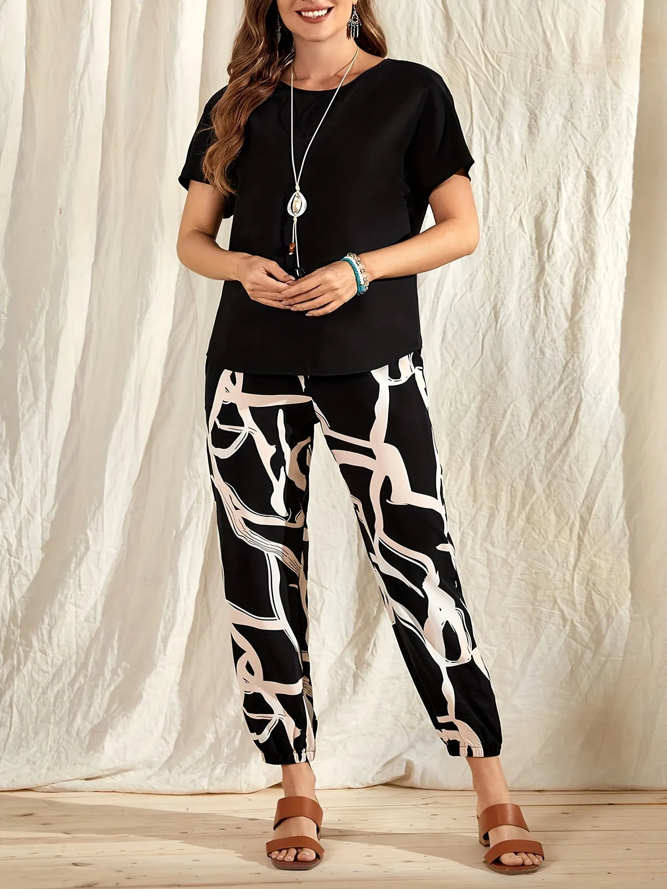 Plus Size Casual Duo - Crew Neck Short Sleeve Top & Colorblock Print Pants Set for Stylish Women